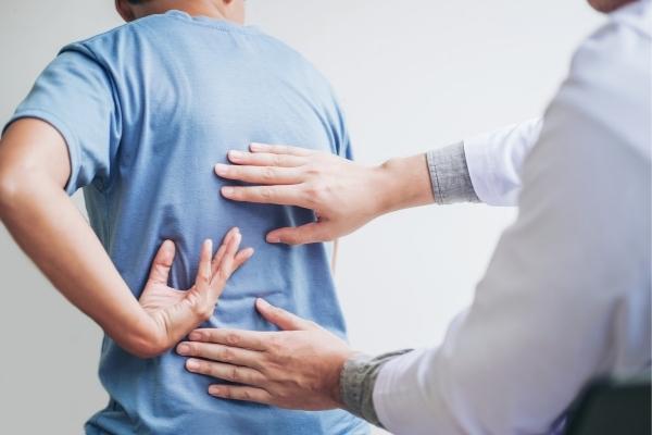 Physical therapist assessing a patient's chronic pain or injury.