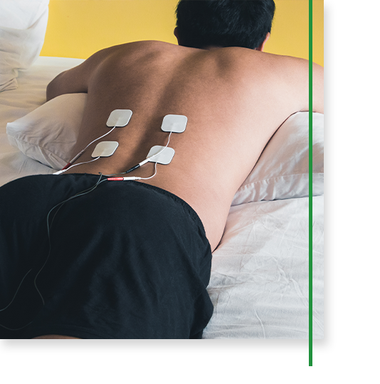 man with tens unit on his lower back