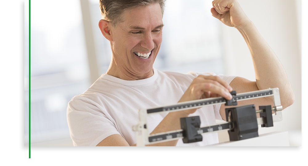 Photo of a man happy on weight scale