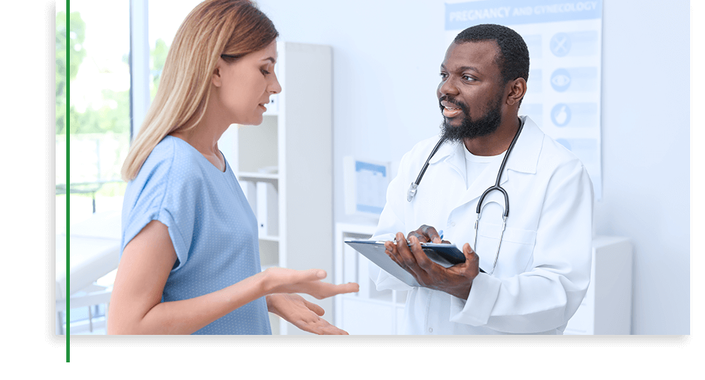 male doctor speaking with female patient