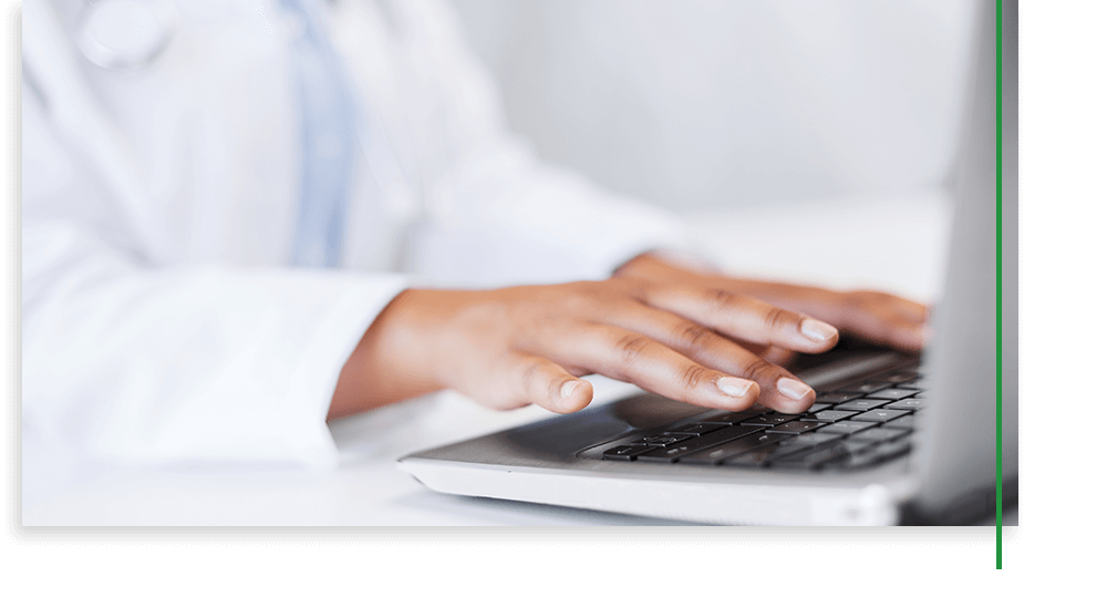 doctor typing on laptop
