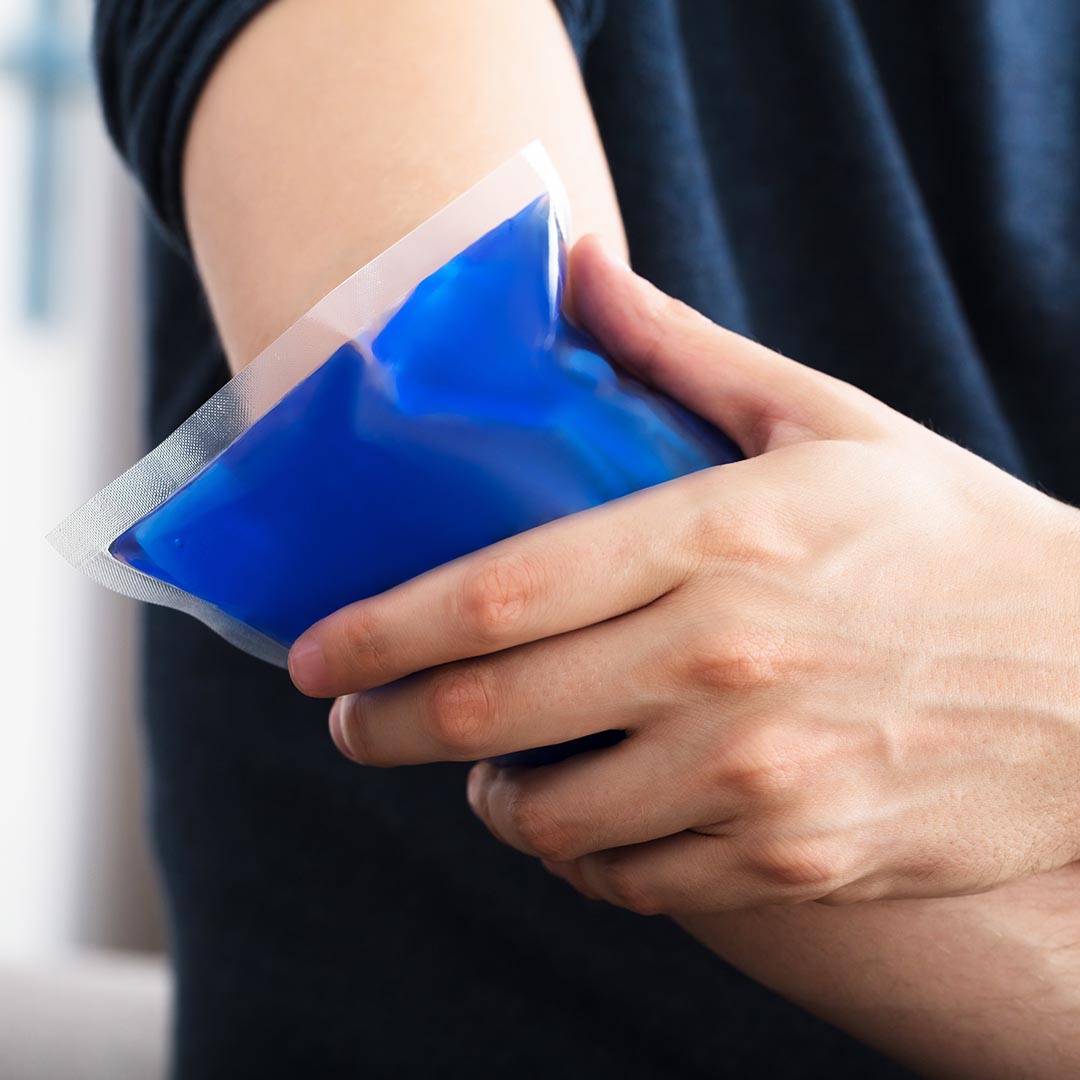 Man holding an ice pack on his elbow
