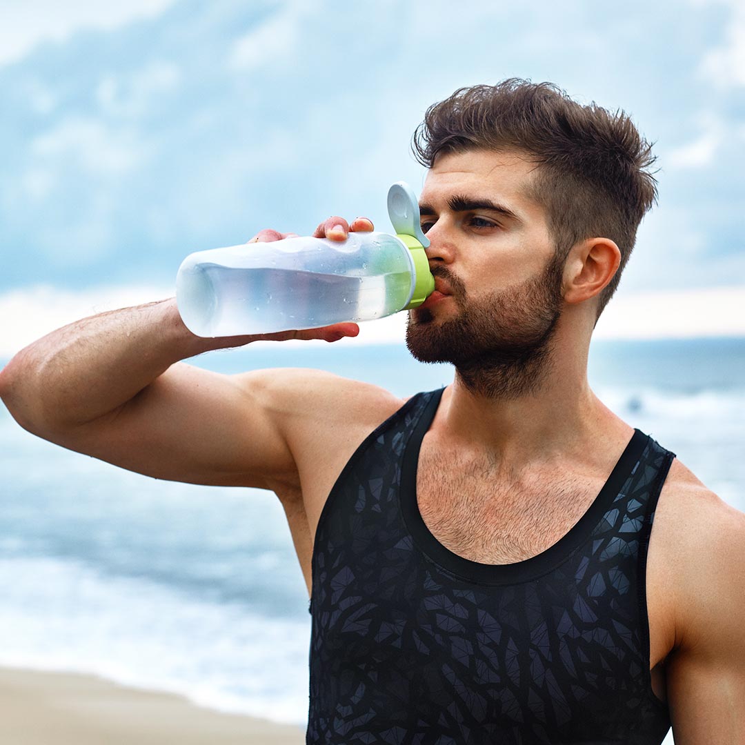 Athletic man drinking water
