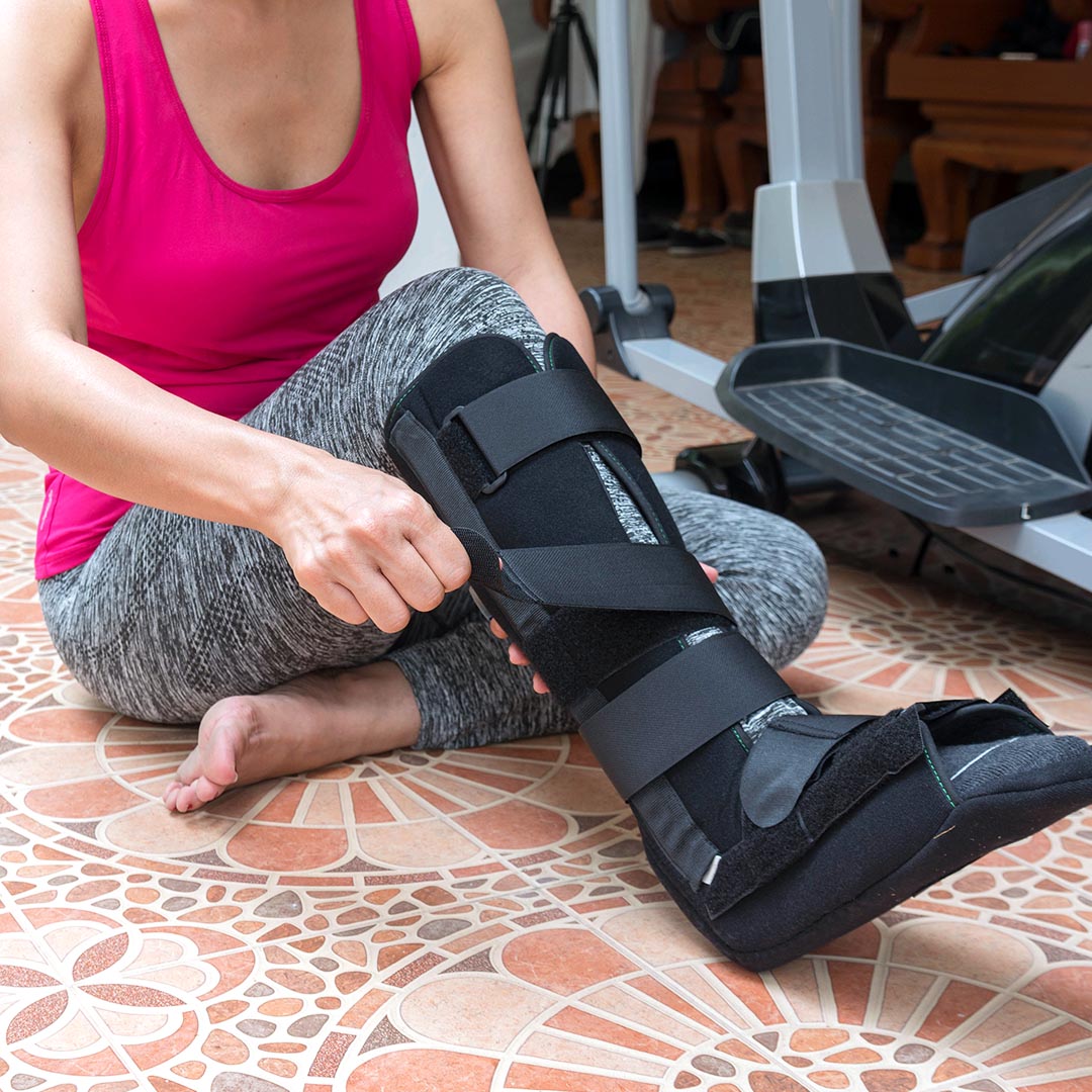 Woman wearing medical brace to help ankle heal